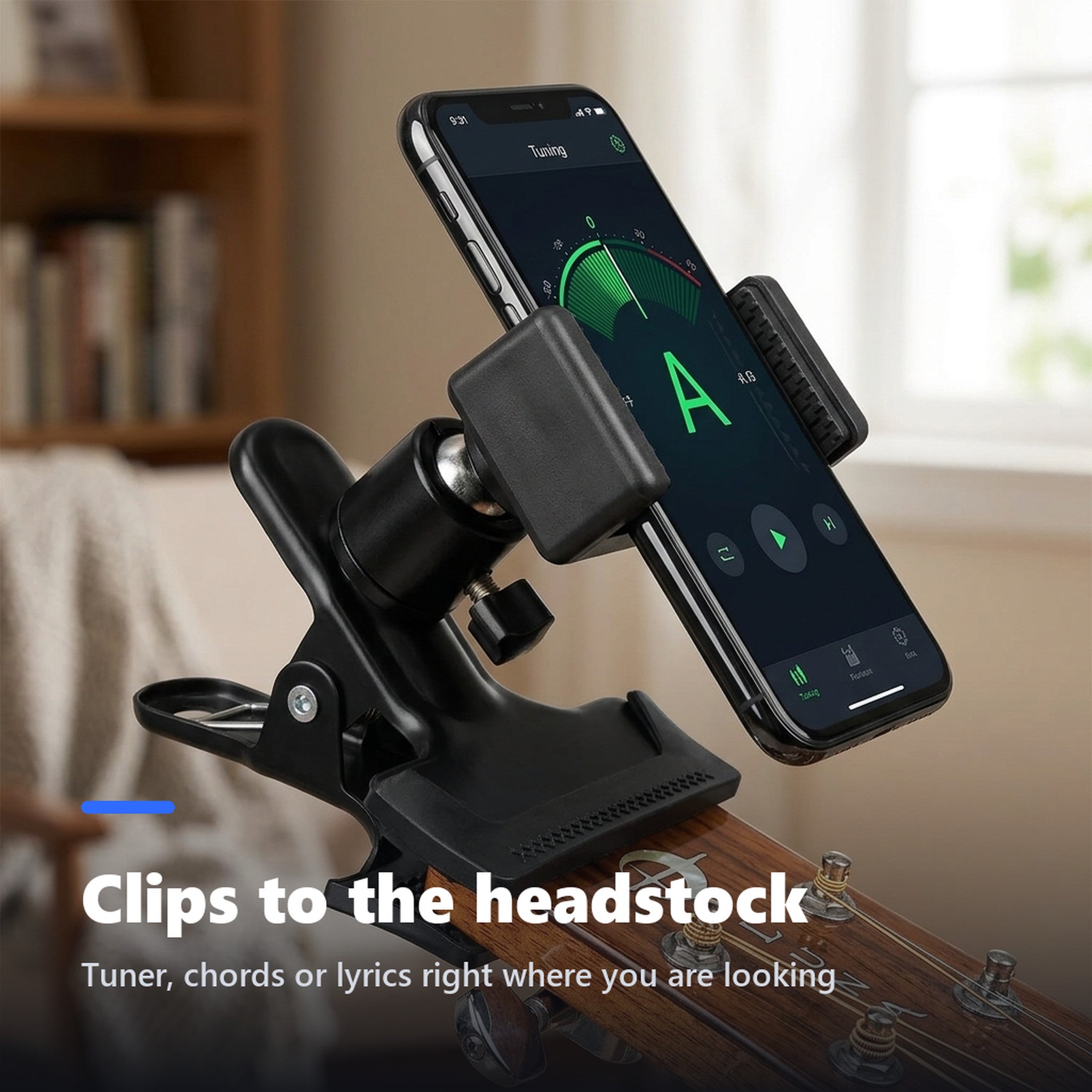Phone mount clipped to an acoustic guitar headstock holding a smartphone